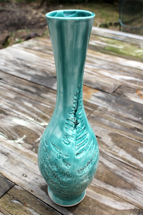Tall green vase with leaf inlay